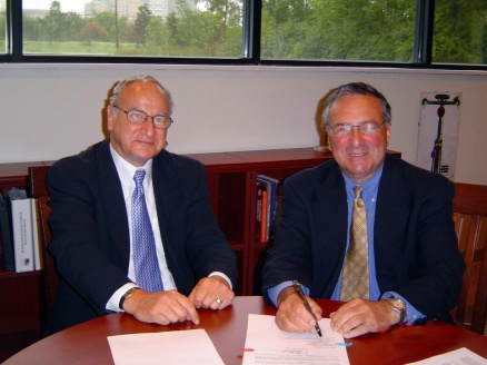 Robert Genco and Allen Barnett sitting at a table. 