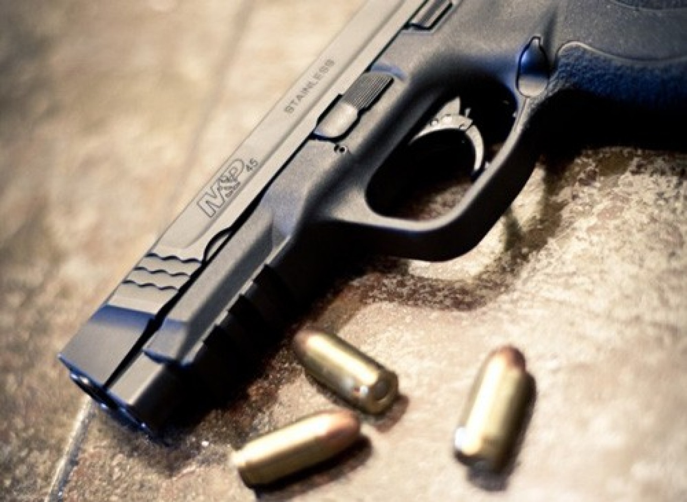 Gun and bullets on a table. 