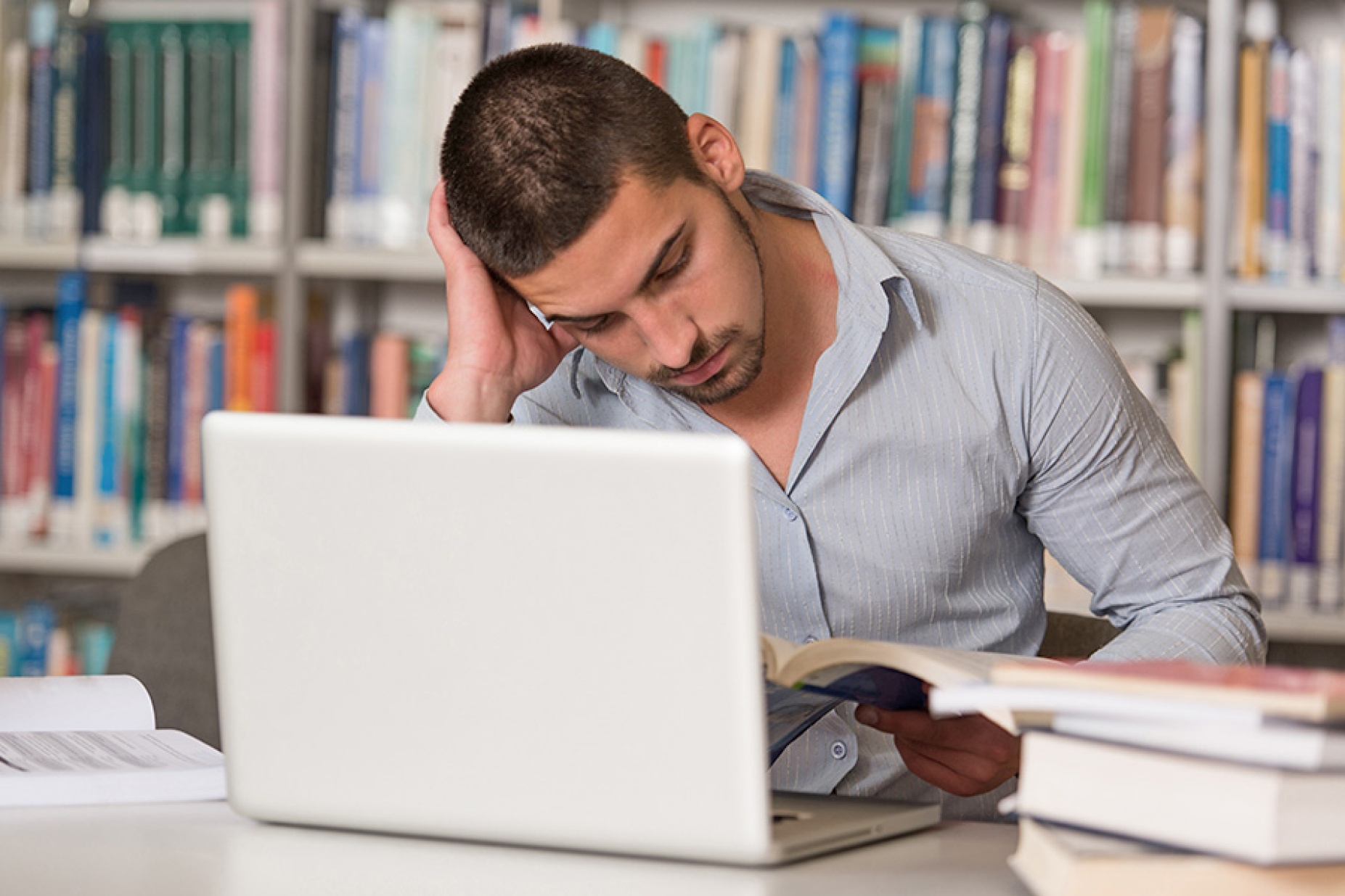 Student looking distraught while reading. 
