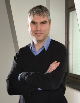 Fraser Sim standing with folded arms. 