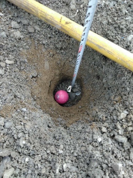 Zoom image: A spray-painted sphere is buried at a known location and depth before the blasts. By tracking where these projectiles land after an explosion, scientists can gain information about the dynamics of a blast. The balls were homemade, crafted earlier in the week from plaster injected into ping pong balls that were later cut away. Credit: Sierra McCollum 