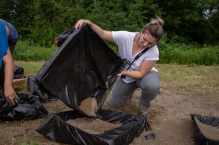 Zoom image: Julia Boyd, a student from the University of Missouri-Kansas City, was part of a team that studied debris thrown out by the explosion. The debris, called ejecta, was collected in shallow boxes placed at varying distances from the epicenter. Credit: Meredith Forrest Kulwicki 