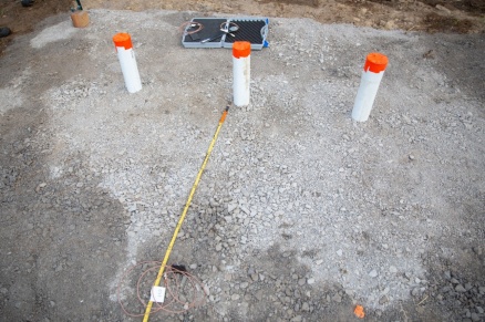 Zoom image: A blast pad. The white tubes mark locations where explosive charges will later be placed. Credit: Meredith Forrest Kulwicki 