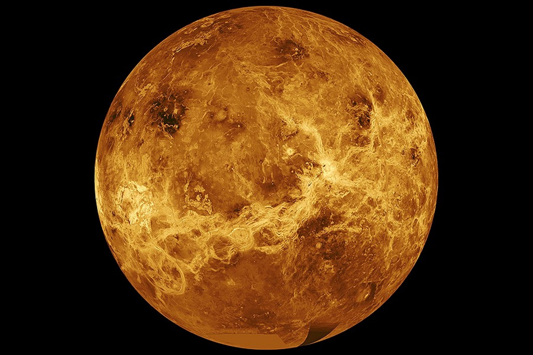 Computer simulated global view of the surface of Venus against a dark background. 