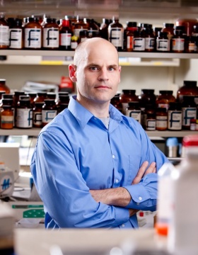 Dietz in lab with arms folded. 