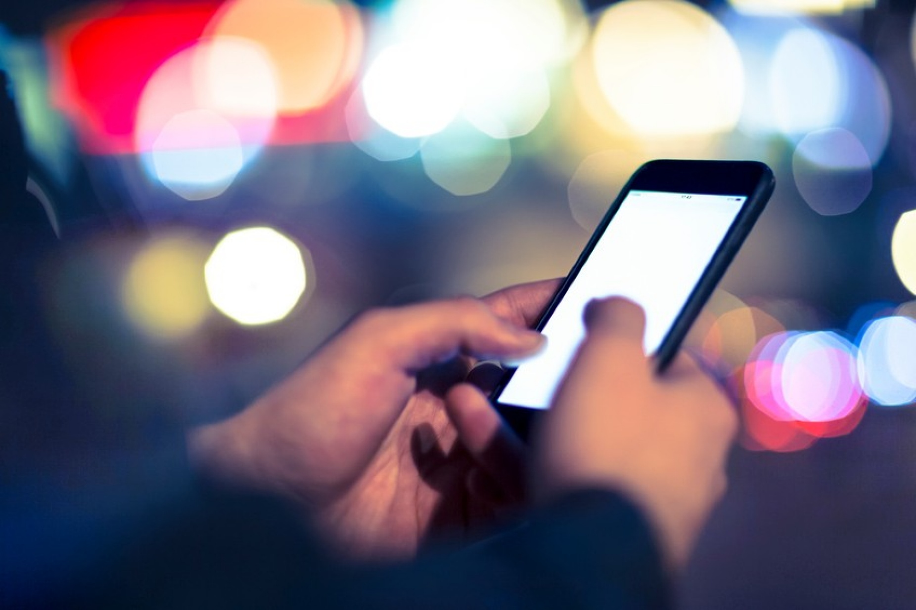 Close up of hands of someone operating a smartphone. 