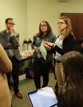 Zoom image: UB student and Chautauqua County native Kelly Mosher (standing, right) meets with Chautauqua County Senior Planner and UB alumnus Patrick Gooch (far left) and Katelyn Walley-Stoll, agriculture program community educator for the Cornell Cooperative Extension Chautauqua County. 