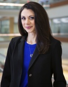 Jennifer Meka standing with med school atrium in background. 