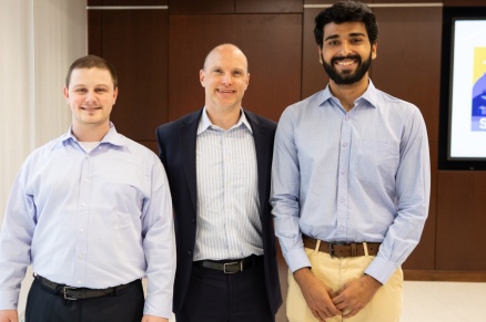 Zoom image: UB students Chris Sbarra (left) and Lavkesh Rajwani (right), with Dan Keating, engineering manager for National Grid’s technical sales and support team in New York. Credit: Douglas Levere / University at Buffalo 
