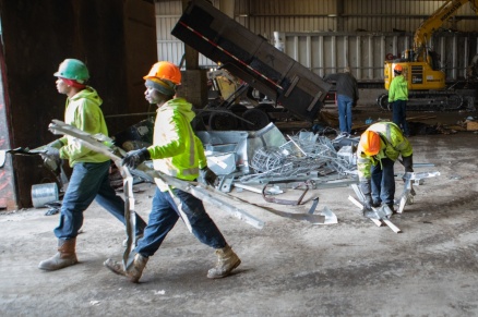 Zoom image: Workers separate out metal from other debris at Triad Recycling and Energy, one of the corporate partners in the new carbon reduction class at UB. Credit: Douglas Levere / University at Buffalo 