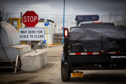 Zoom image: A pick-up with dump trailer waits to be weighed at Triad Recycling and Energy. As part of the carbon reduction class, students suggested that the company create an incentive system to encourage truck drivers to turn off their engines while waiting in line. Credit: Douglas Levere / University at Buffalo 