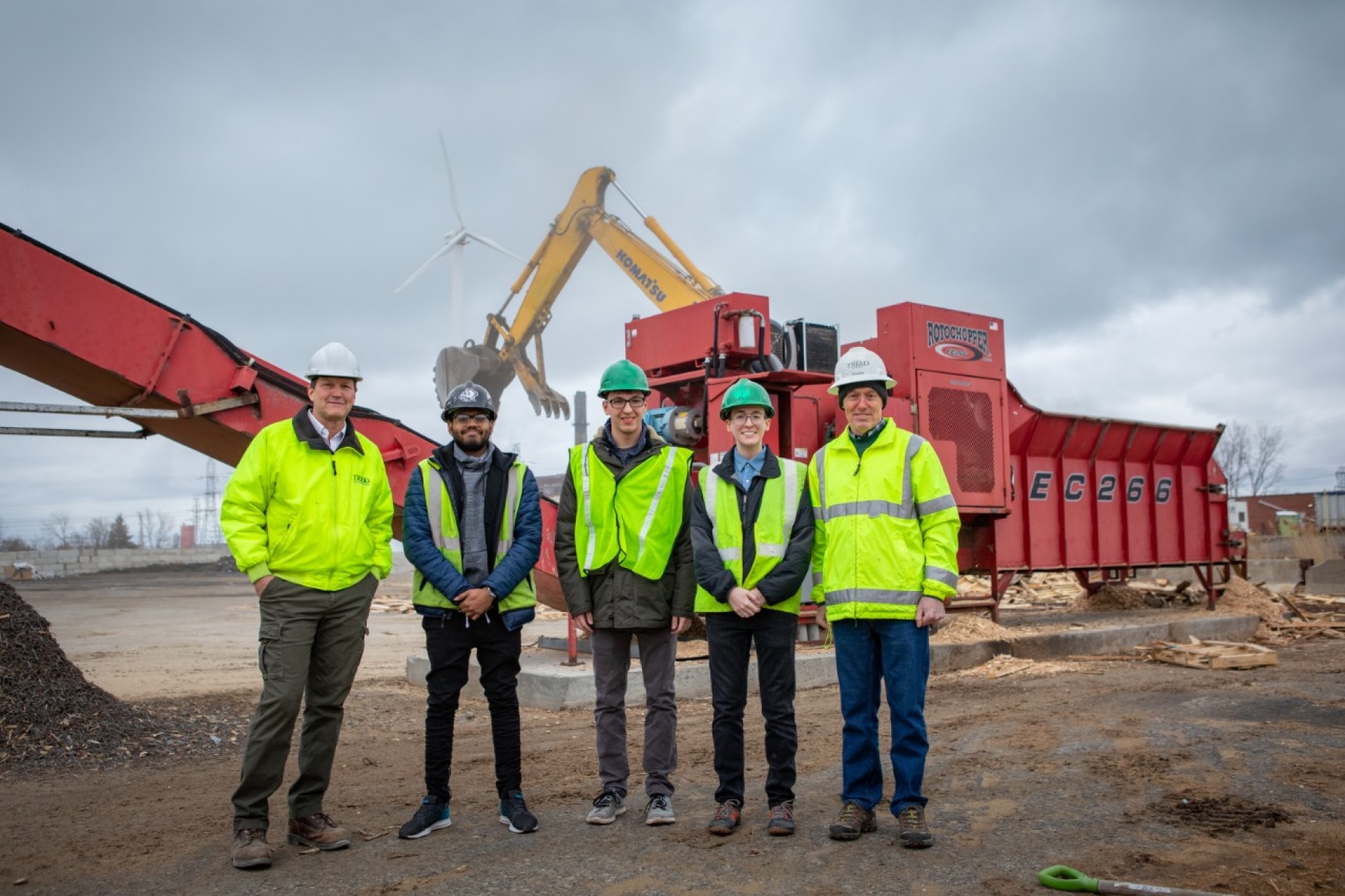 Zoom image: Chris Guard (far left) and John Hannon (far right) are co-owners of Triad Recycling and Energy, one of corporate partners in the new carbon reduction class at UB. Left to right, starting from Guard&rsquo;s right, are UB students Dan Moses, Todd Glosser and Sean O&rsquo;Neill, who are helping Triad reduce its carbon footprint. Not pictured: Triad&rsquo;s third co-owner Ken Rawe. Credit: Douglas Levere / University at Buffalo 