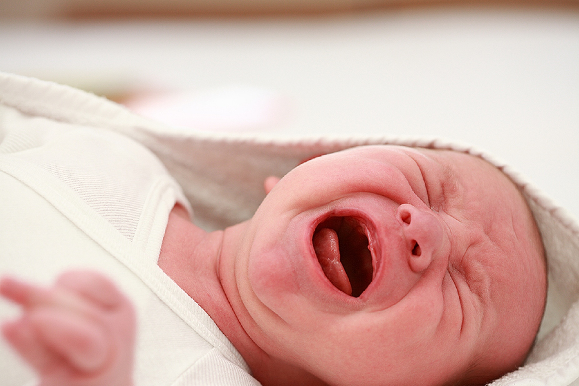 Distressed, crying newborn baby. 