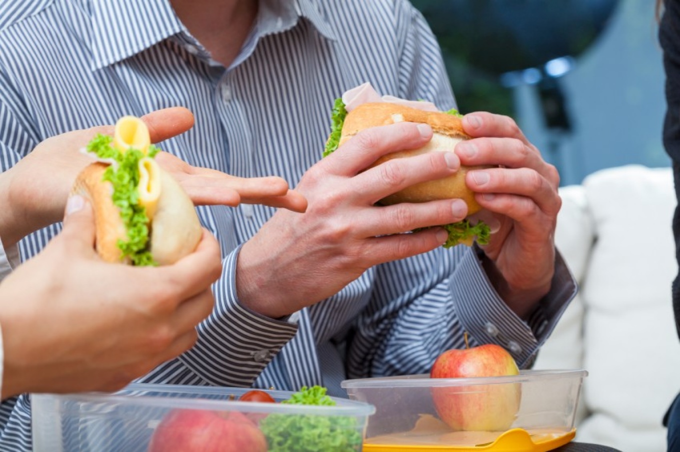 People eating sandwiches.