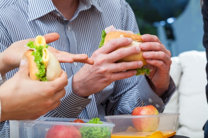 People eating sandwiches. 