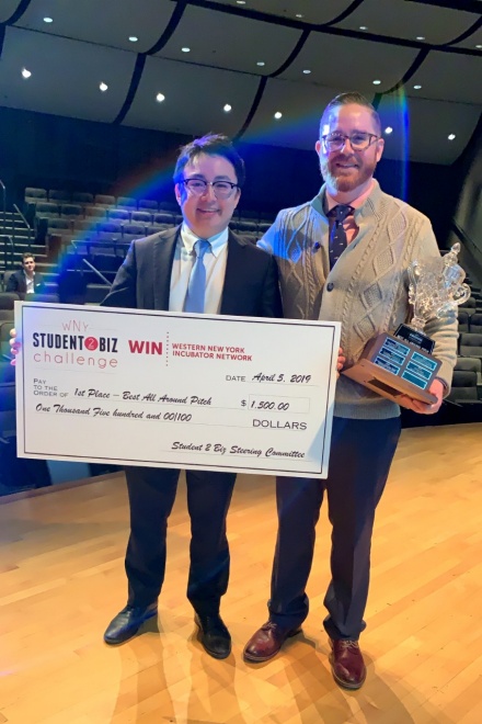 Zoom image: Left to right: SurgIno co-founders Jinwei Hu, MD, and Thomas Langan, MD, at the Student 2 Biz competition in Western New York. Not pictured are co-founders Tatiana Boyko, MD, and Stephen Chiang, MD. All four co-founders are general surgery residents at UB. Credit: Alex Cleary Pelc 