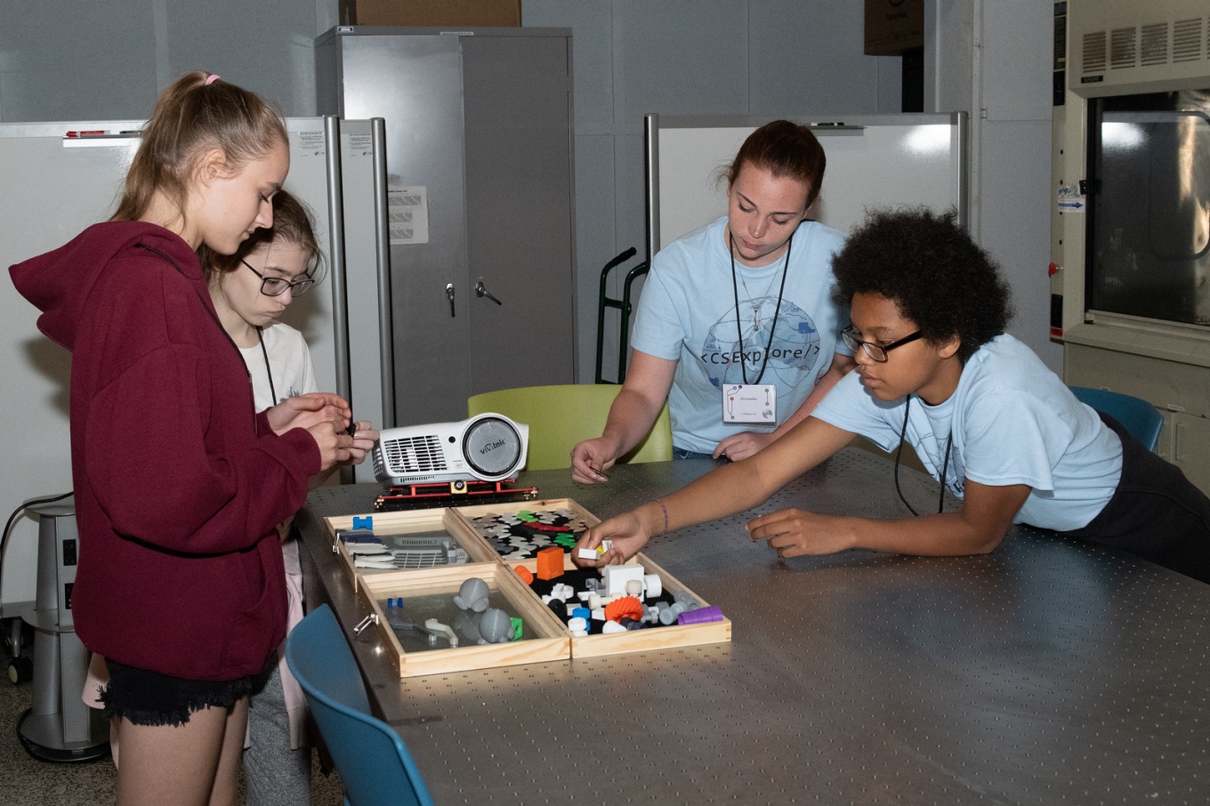 Four students working inside UB's Digital Manufacturing Lab at last year's CSExplore Camp. 