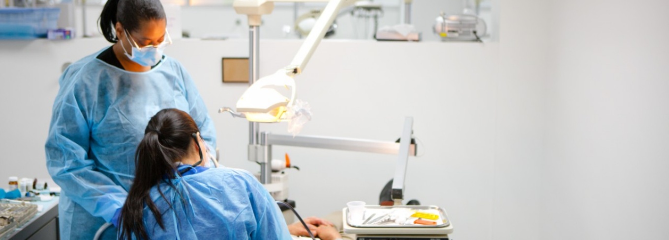 Dentists in scrubs working in clinic.