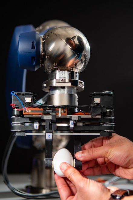 Zoom image: A robotic gripper developed in the lab of University at Buffalo engineer Ehsan Esfahani uses repulsion between magnets to adjust the stiffness of its grip, improving safety. The gripper can grasp objects as fragile as a berry or an egg. Credit: Douglas Levere / University at Buffalo 