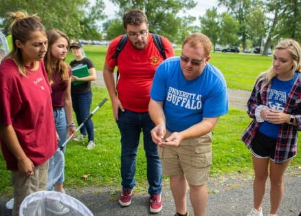 Zoom image: In an ecological methods course this semester, Nicholas Henshue (center, blue shirt), clinical assistant professor in the UB Department of Environment and Sustainability, led students in tagging monarchs to help track the insects&rsquo; spectacular migration. Credit: Douglas Levere / University at Buffalo 