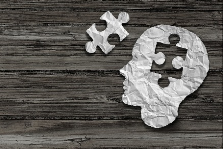 An illustration showing a puzzle piece and a head with a section the shape of the puzzle piece missing. 