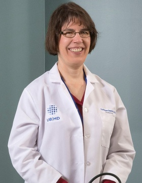 Kathleen E. Bethin, MD, PhD, standing, in white coat. 