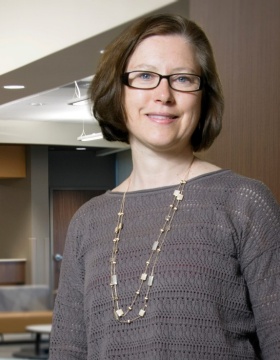 Lucy Mastrandrea, MD, PhD, standing with UBMDPediatrics sign in background. 