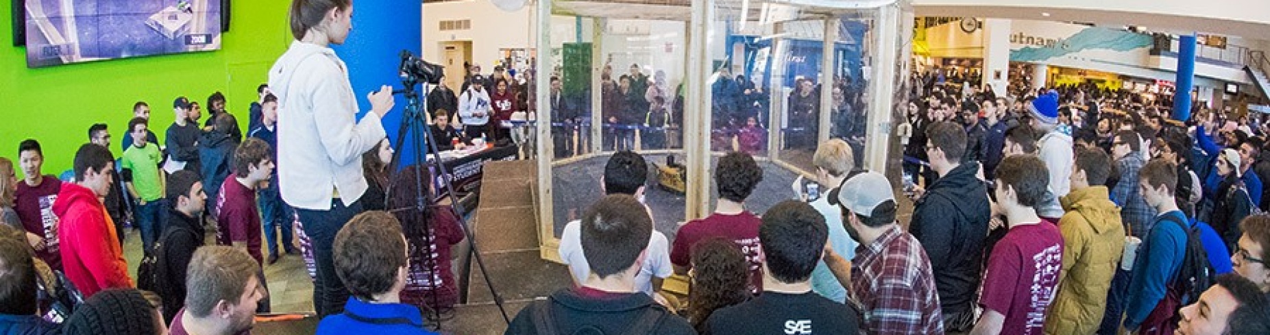 Students gather in the Student Union to watch robot wars.