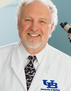 headshot of Anthony Campagnari in white lab coat. 