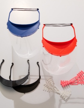 Face shields and comfort bands on table. 