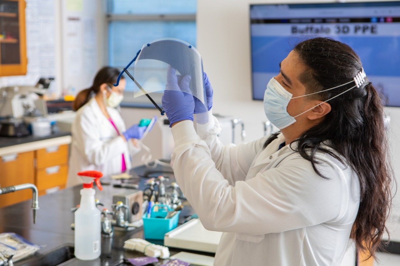 Students assembling face shields in lab. 