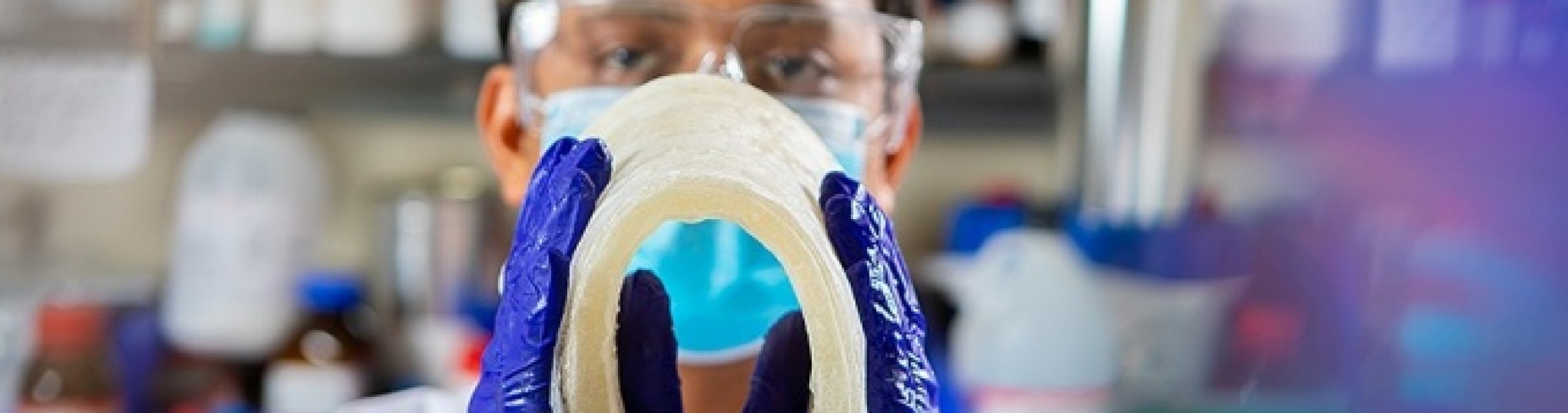 PhD student Pratahdeep Gogoi​ bends a sheet of CoolPak Hydrogel. The advanced material provides high-impact cooling while remaining flexible even when frozen, enabling a more effective and comfortable cooling experience. Photo: Douglas Levere. 