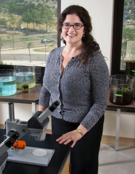 Jennifer Surtees standing in lab. 