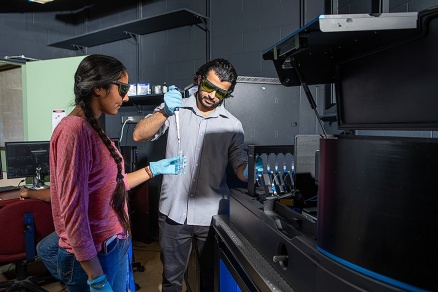 Zoom image: Pictured in 2019, UB physics PhD students Taranpreet Kaur (left) and Ibraheem Alshareedah work in UB biophysicist Priya Banerjee's lab. A $2 million grant from the National Institutes of Health will support the Banerjee group's research on protein-RNA condensates. Credit: Douglas Levere / University at Buffalo 