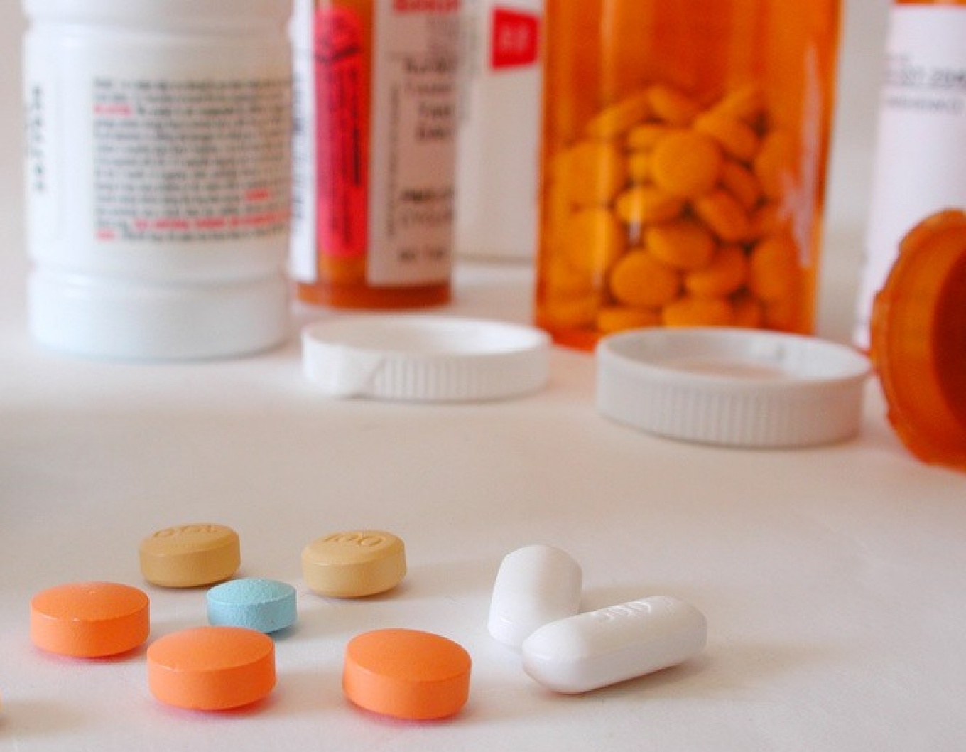 Pills and pill bottles on table. 