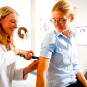Female patient receiving a medical exam by a female physician. 