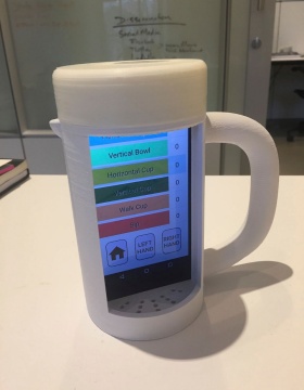 Zoom image: Placed inside the special 3D-printed mug, the mRehab smartphone app gives users feedback on their movements. 