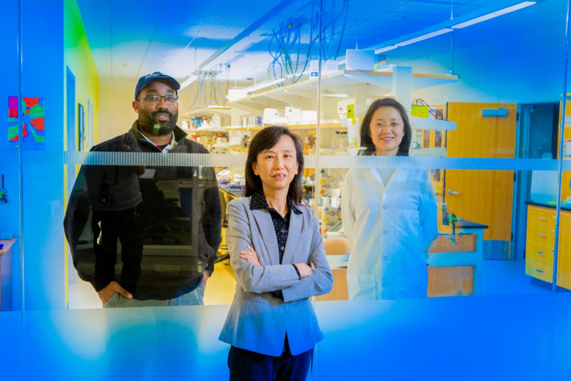 L to R: Photo illustration taken of the individuals separately shows Jamal Willliams, Zhen Yan and Qing Cao in Yan's lab. 