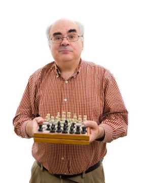 Ken Regan standing with chess board in his hands. 