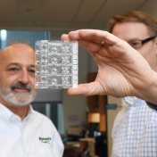 Richard Montagna (left) views the Rheonix CARD (r) Cartridge held by UB&rsquo;s Michael Buck. 