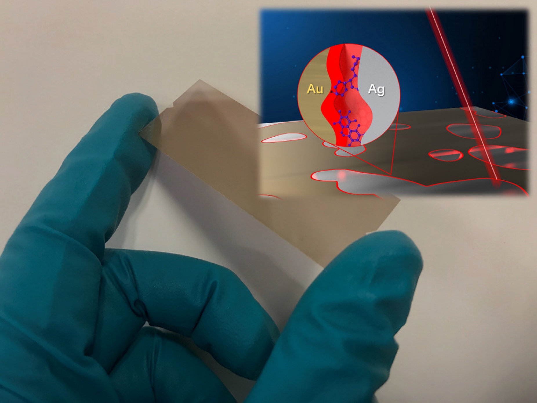 An illustration of the chip. A gloved hand holds a thin gold film which is struck by a beam of red light. An inset shows the chemical element abbreviations for gold and silver and the particles illuminated by the light. 