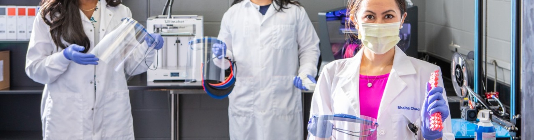 UB students Joycelyn Moss, Philip Sales and Shaina Chechang hold PPE materials. 