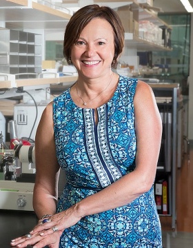 Gabriela Popescu standing in lab. 