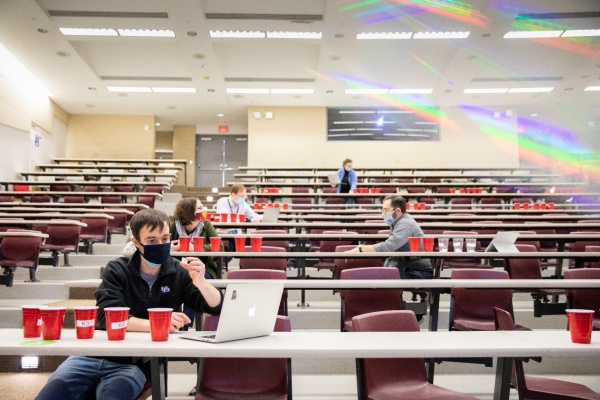 Zoom image: Judging looked a bit different this year — a much larger room and a lot more distance. Judges pictured, from the bottom row up, are UB faculty members David Lacy (first row); Andrea Markelz (left) and Luis Velarde (right), in the same row; David Heppner; and Ekin Atilla-Gokcumen (standing). Credit: Meredith Forrest Kulwicki. Additional photos of the crystal contest judging are available for download. 