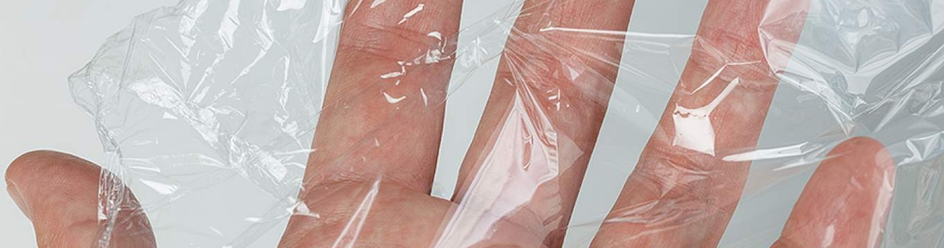 human hand with cling wrap around it.