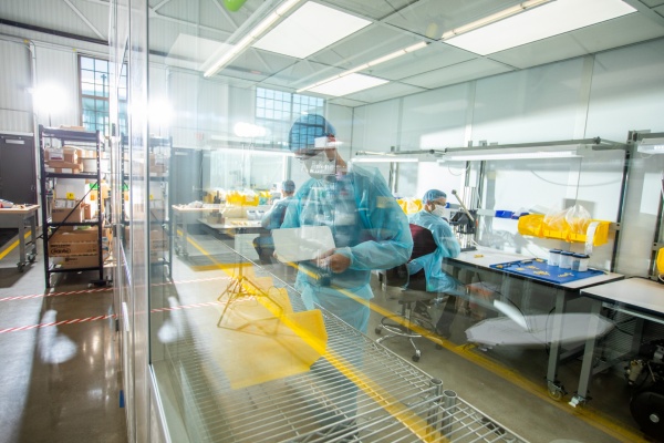 Zoom image: Windows look in on a clean room, part of Garwood Medical Devices’ pilot production line, which the company is developing for its BioPrax™ device. Pilot manufacturing is an important step toward bringing medical devices to market, demonstrating that a product can be made consistently in large quantities. Garwood Medical Devices will be producing BioPrax™ for use in clinical trials, says Wayne Bacon, president and CEO. Credit: Douglas Levere / University at Buffalo 