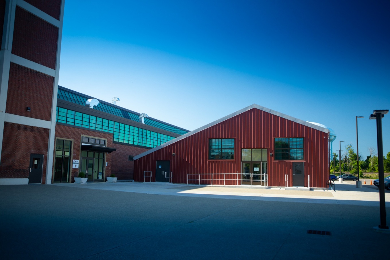 Zoom image: In December 2020, Garwood Medical Devices moved into its new headquarters on Northland Avenue in Buffalo. The building, nicknamed the &ldquo;Red Shed,&rdquo; is next door to the Northland Workforce Training Center (seen at the left), and the company hopes the location will facilitate recruitment of students and graduates of the center as employees. Credit: Douglas Levere / University at Buffalo 
