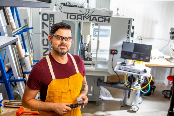 Zoom image: William Purcell, an engineering technician at Garwood Medical Devices, was recruited to the company through the Northland Workforce Training Center next door, where Purcell is a student in the machine tool technology program. "Garwood Medical Devices wanted to bring someone on to help with the shop, with fabrication and assembly. Once I found out more about the company, I was excited that I could use my new skills to do something that's potentially going to help people. That's my goal," Purcell says. As time goes on, he will help to improve production processes and train new machinists at Garwood Medical Devices. Credit: Douglas Levere / University at Buffalo 