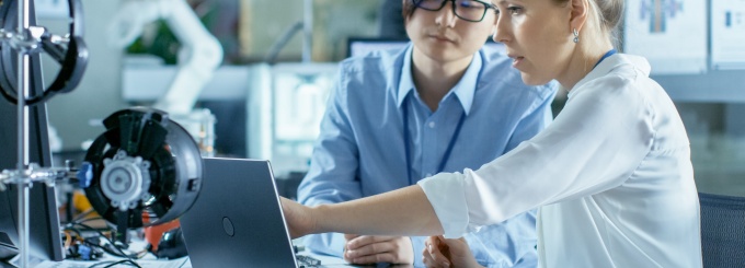 Two women scientists working in a lab. 