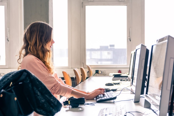 Young student working in bright computer lab. 